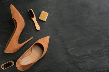 Stylish footwear with shoe care accessories on black table, flat lay. Space for text