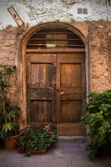 A door in an old building in the historic medieval village of Scansano, Grosseto Province, Tuscany, Italy
