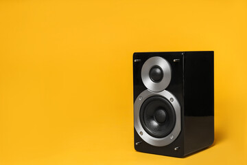 Modern powerful audio speaker on yellow background, space for text - obrazy, fototapety, plakaty