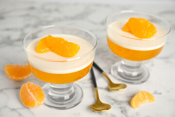 Delicious tangerine jelly on white marble table, closeup