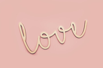 Decorative Wooden letters word LOVE on light pink background, Happy Valentines Day Concept