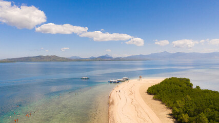 The island of white sand with mangroves. The sea landscape of Honda Bay, view from above. Beautiful white sand beach. Tourist destination.