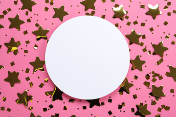 Blank card and shiny golden confetti on pink background, flat lay. Space for text