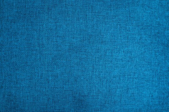 Background texture of upholstery fabric in blue green color. Close-up, concept and design
