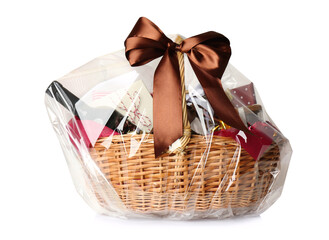 Wicker basket full of gifts isolated on white