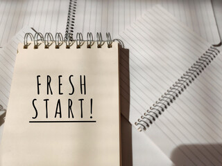 Inspirational and motivational concept. FRESH START text on notebook background. Stock photo.
