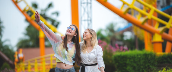 LGBT concept, Young women at Amusement theme park enjoying, Smiling multiethnic women enjoying and...