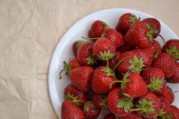Strawberry from farmland. Freshly picked strawberries. Organic berry. Vintage paper background. Sweet berry. Village garden harvest.