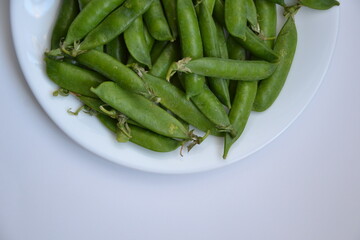 Green pea pods from farmland. Pea freshly picked. Organic spring pea pods. Fresh vegetables. Healthy eating. Country garden harvest.