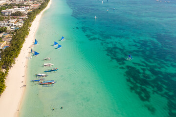 Beautiful lagoon with boats and tourist beach. White beach on the island of Boracay, top view.