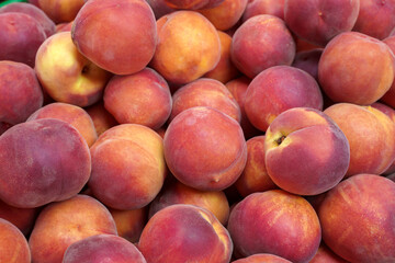 Ripe peaches on a market.  Fruit peaches background