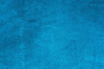 Background texture of upholstery velvety fabric in blue green color. Color trends, concept and design