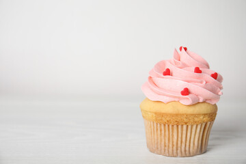 Tasty sweet cupcake on white table, space for text. Happy Valentine's Day
