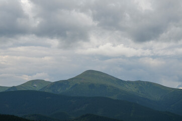 Part of Chornohora range with the highest mountain of Ukraine Hoverla in cloudy summer day. Panoramic view, Carpathian Mountains, Ukraine