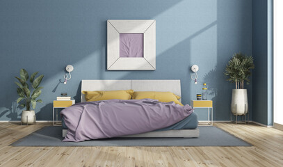 Colorful double bed in a modern room with blue walls