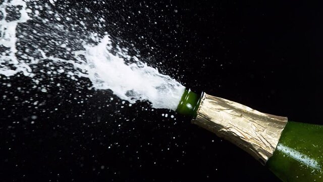 Super slow motion of Champagne explosion, opening champagne bottle closeup. Filmed on high speed cinema camera, 1000fps