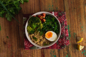 Veggie bowl of noodles on top of wooden table, with flat design.