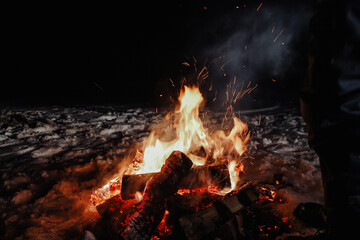 Bonfire with beautiful sparks in winter at night