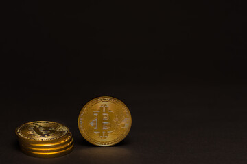 stack of golden shiny valuable bitcoin standing on a black background left