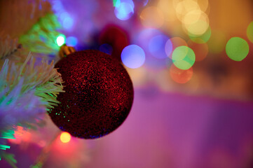 Christmas red ball toy on a background of Christmas lights