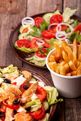   Two salad.. Vegetable and meat salad of mozzarella, cheese, olives, chicken, cucumber, tomatoes and salad salad of white onion, cucumber, tomatoes, lettuce, parsley and french fries potato