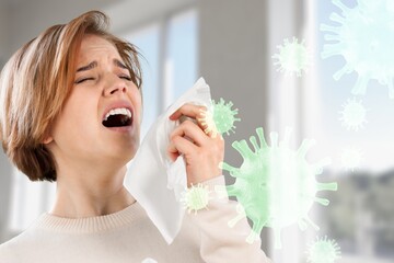 Allergies or cold concept. Young woman blowing nose