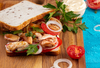 Sandwiches with chicken meat, cherry tomato, onion and chicken meat, marinated cucumbers, mozzarella cheese