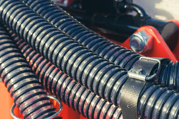 Close-up of a bundle of corrugated fertilizer pipes for an agricultural seeder.