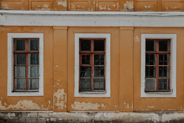 Fototapeta na wymiar A window in an old house, historical architecture in the Russian style, signs of wear and tear.