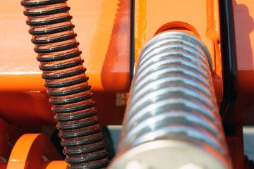 Close-up of technical units and mechanisms of agricultural machinery. Springs and suspension...