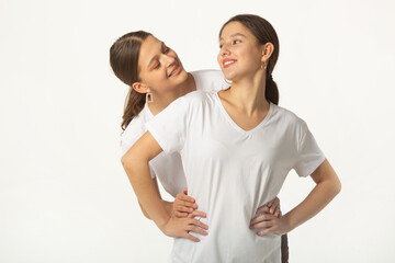 two beautiful young women in white t-shirts on a white background