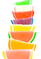 A Variety of Multicolored Candy Fruit Slice on a White Background