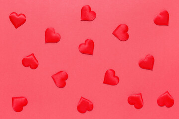A pattern of romantic hearts on a red background. Confetti. The texture of Valentine's Day. The...