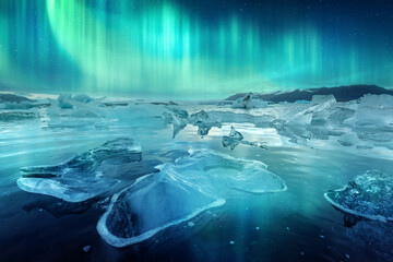 Aurora borealis northen light and icebergs in Jokulsarlon glacial lagoon. Vatnajokull National Park, southeast Iceland, Europe. Landscape photography