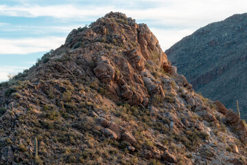 Mountain peaks against blue skies and sparse clouds in Tucson Mountain Park