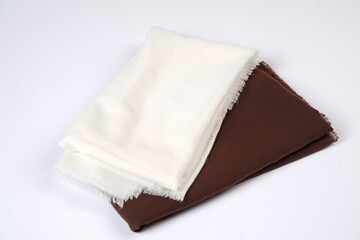 Brown and white veil.  Combination of several folded and rolled fabrics. Thin fabric texture is commonly used for fashion materials. Fabric mockup for a design template. Blank veil moeslim.