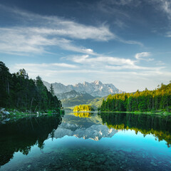 Naklejka premium Fantastic view on mountain lake Eibsee, located in the Bavaria, Germany. Dramatic unusual scene. Alps, Europe. Landscape photography