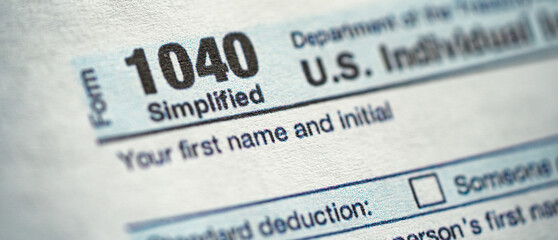 Super close up blurred view of Form 1040, U.S. Individual Income Tax Return. Banner photo