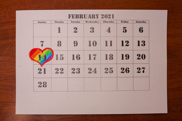 Calendar on which the date of February 14 is marked with a heart. Valentine's Day. Minority SEX....