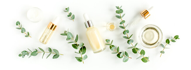 Fototapeta na wymiar Eucalyptus essential oil, eucalyptus leaves on white background. Natural, Organic cosmetics products. Medicinal plant. Natural Serums. Flat lay, top view.