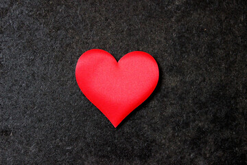 St. Valentine day background. Red heart on dark background