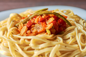 spaghetti with fried eggplant and tomatoes and sweet and sour sauce