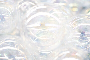 Transparent Shiny Glass Christmas balls, light background, soft focus