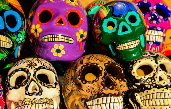 Calacas, wooden skull Day of the Dead masks on market in Cabo San Lucas, Mexico
