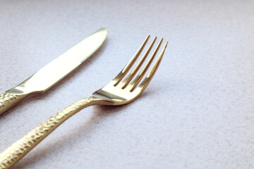 Elegant fork on a knife background on a gray background, space for text