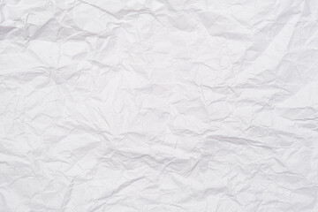 A background of sheet of white crumpled paper with wrinkles, backdrop for design and web