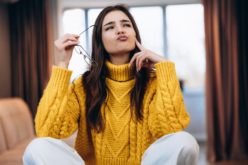 Nice girl wearing glasses and cute sweater is working studying at home. Photo about young...