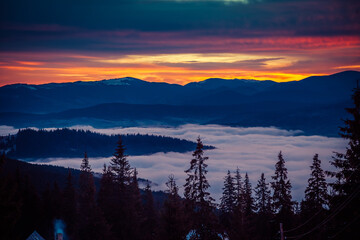 Beautiful dawn in the winter snow-covered mountains and amazingly beautiful clouds