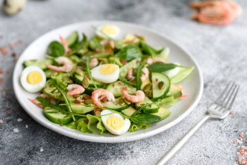 Salad with shrimp, avocado, cucumber, pumpkin seeds and flax seeds with olive oil