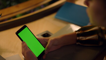 Woman hands using green screen mobile phone. Girl touching mockup smartphone